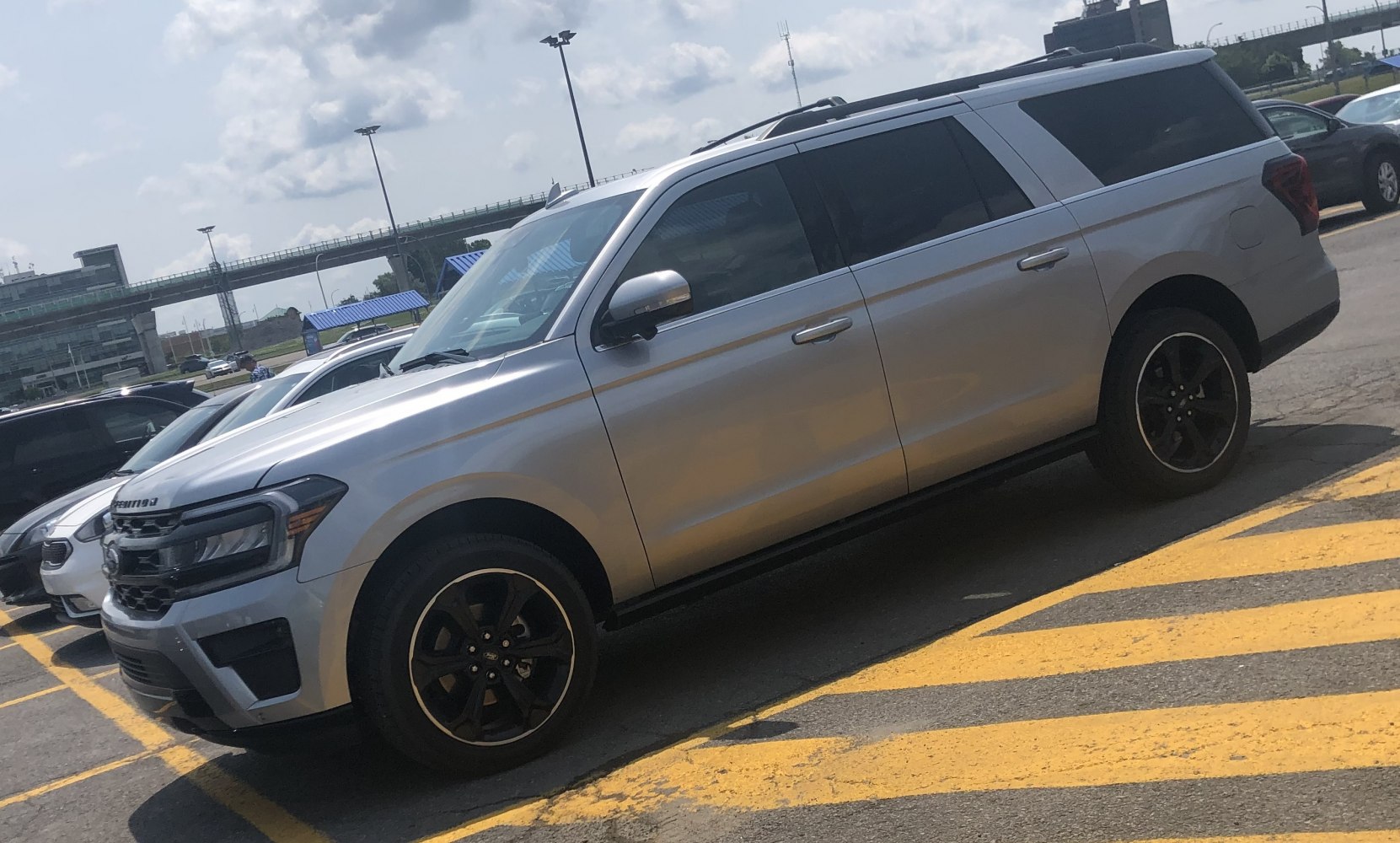 Silver full-size SUV with black alloy wheels and tinted windows