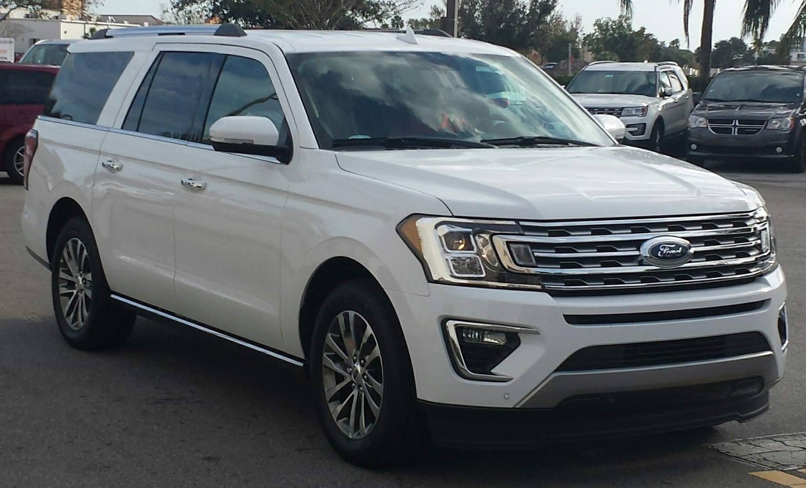 White large SUV front-side view with prominent grille and headlights