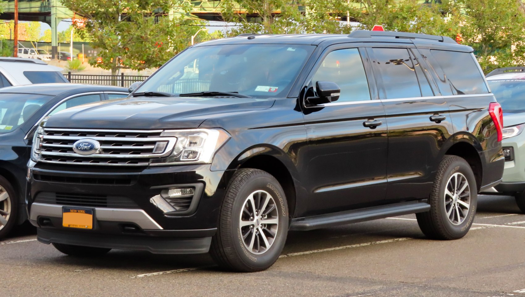 Front and side view of an SUV with chrome grille and tinted windows
