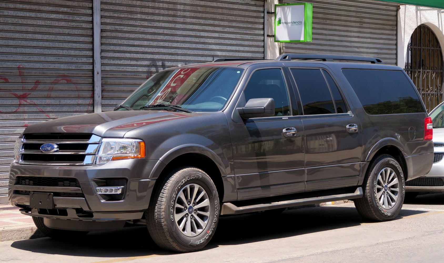 Front side view of large SUV with alloy wheels and tinted windows