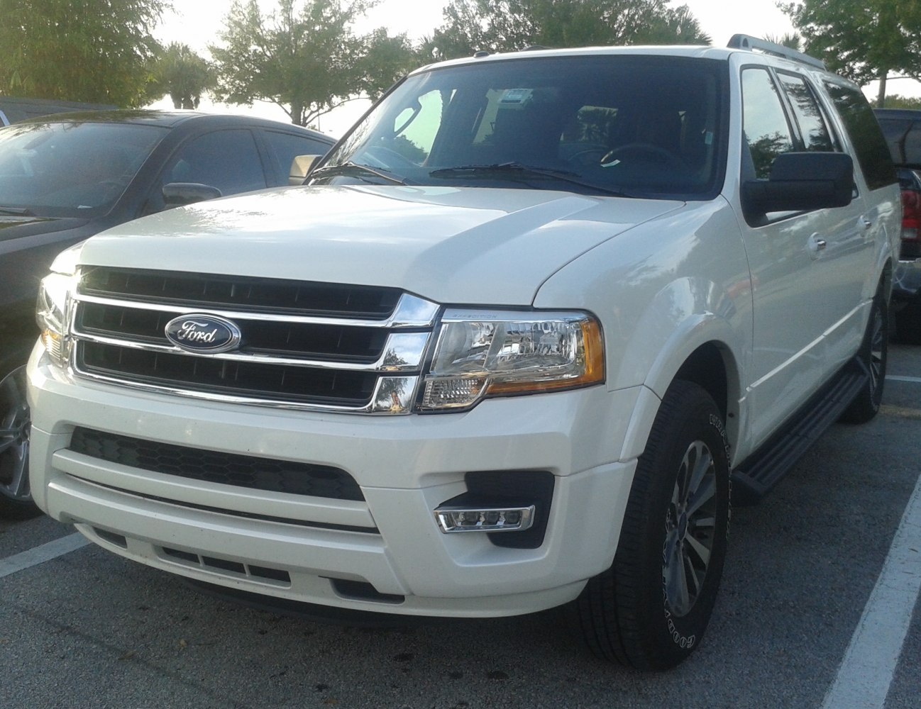 White large SUV with chrome grille and LED fog lights