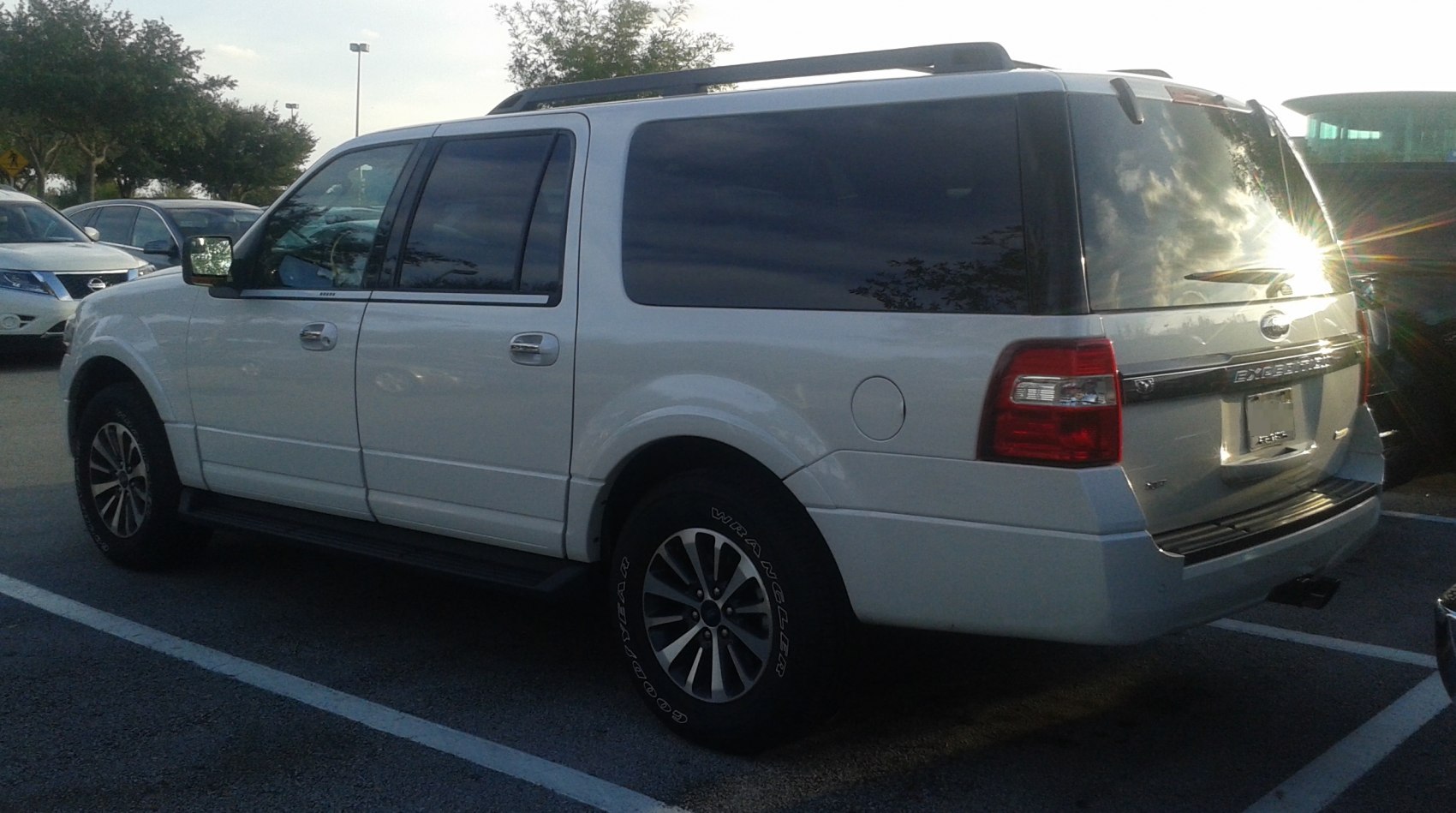 White SUV with black tinted windows and alloy wheels in rear side view