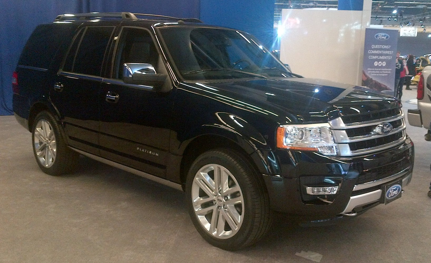 Black large SUV with chrome grille and alloy wheels
