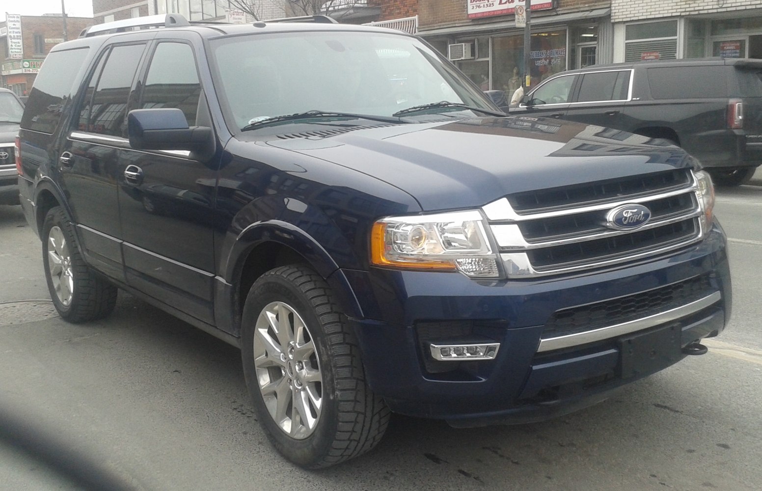 Front-side view of SUV with chrome grille and alloy wheels