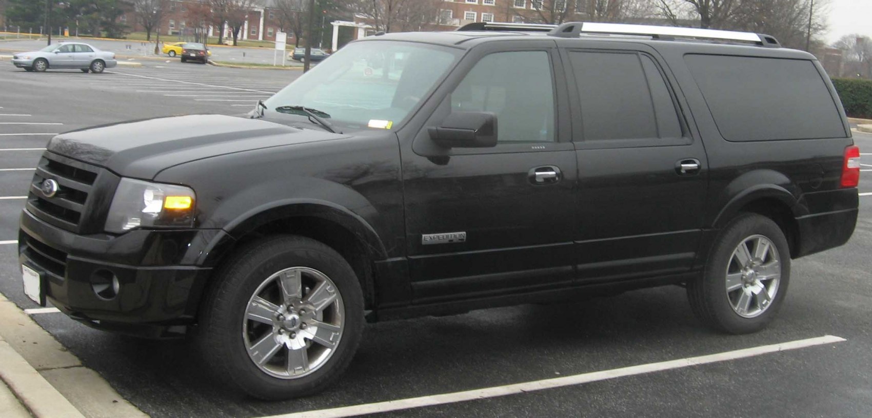 Black full-size SUV with chrome wheels and tinted windows