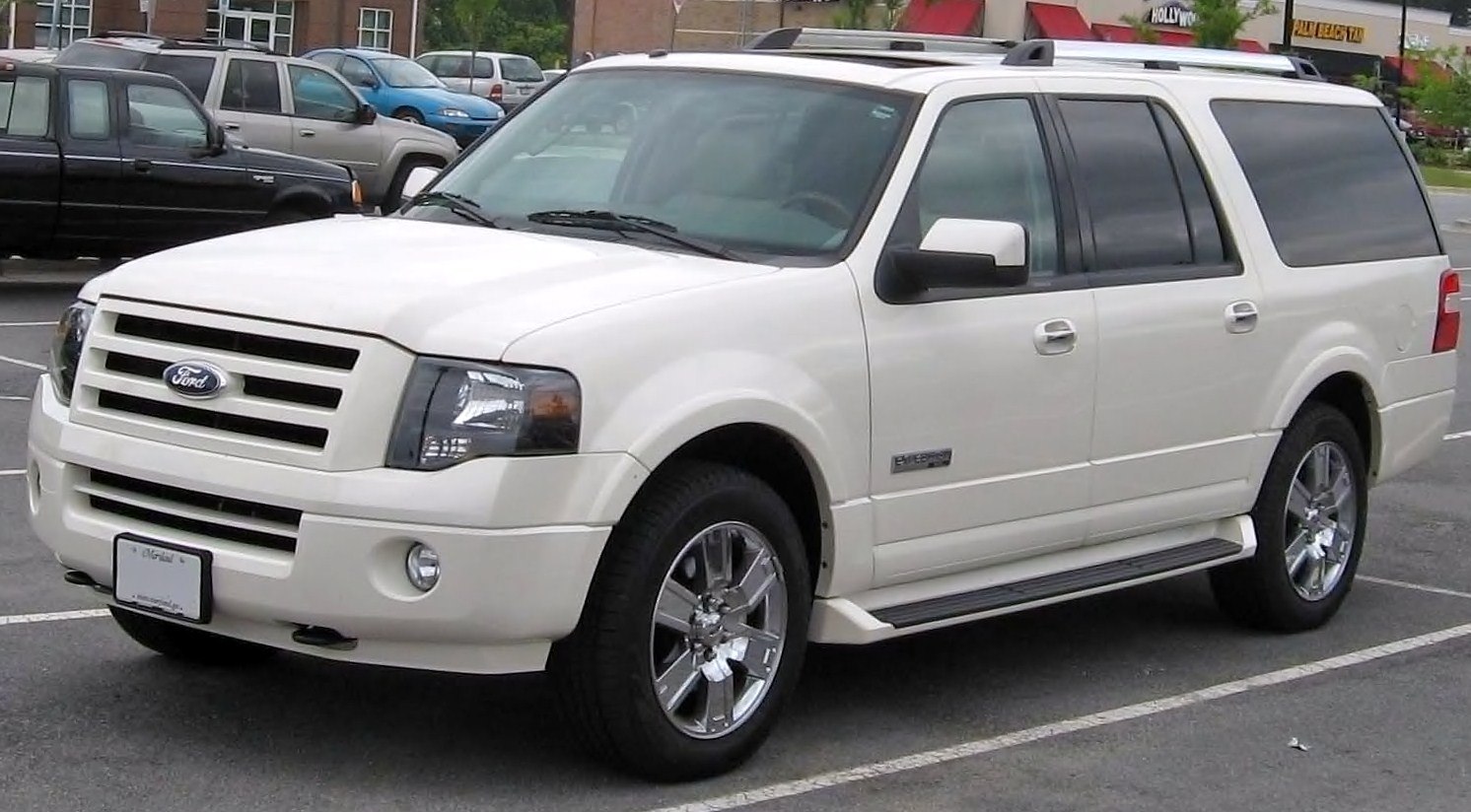 White full-size SUV with chrome wheels and roof rails