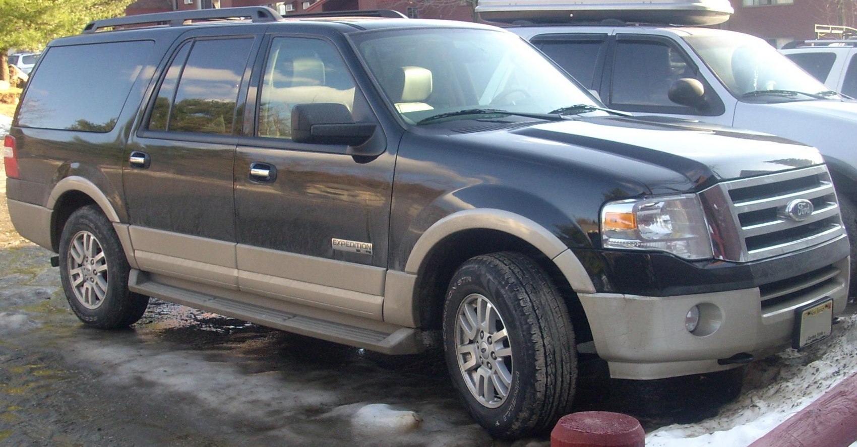 Large SUV front side view with two-tone paint and rugged tires