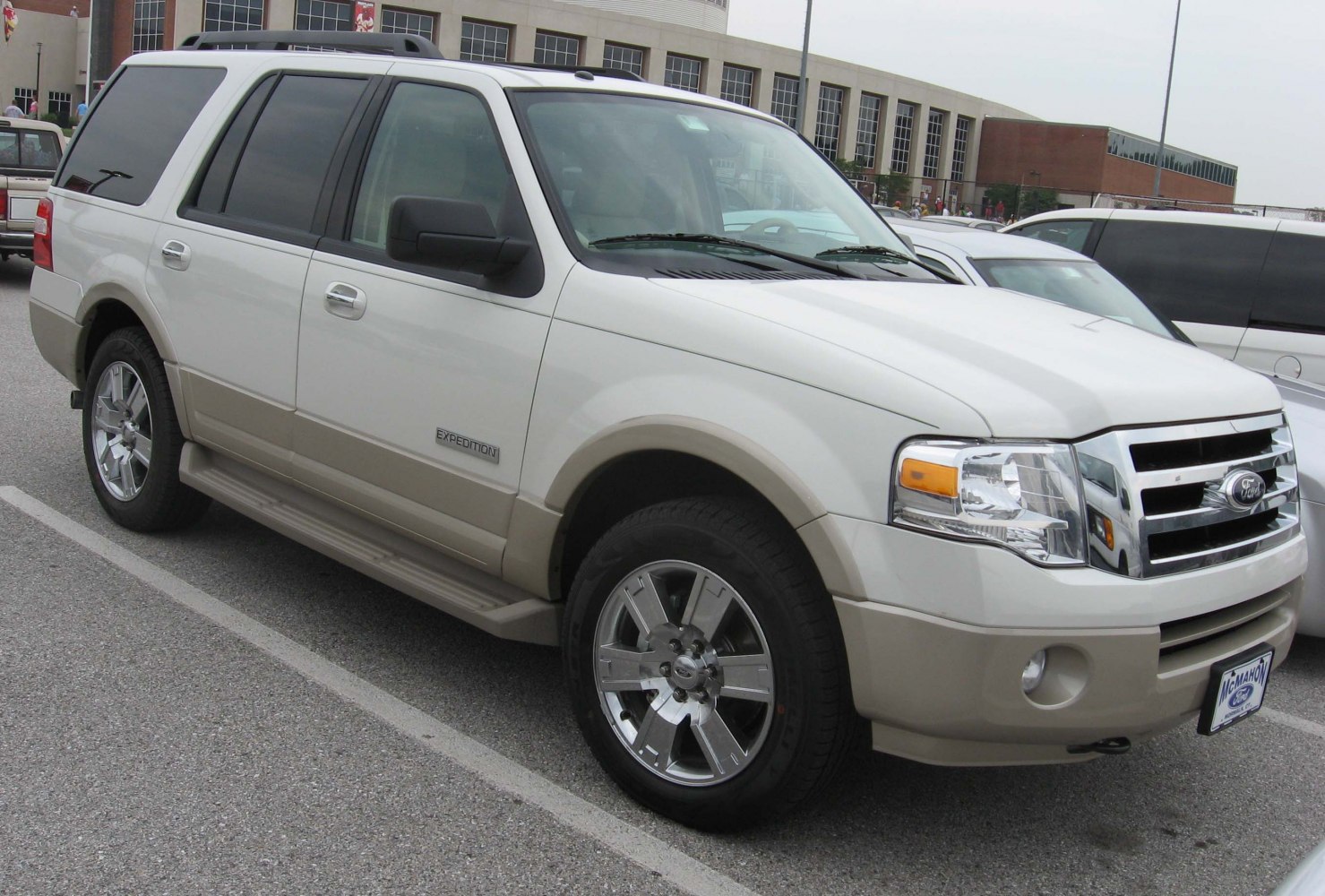 Full-size SUV with chrome grille, side steps, and alloy wheels