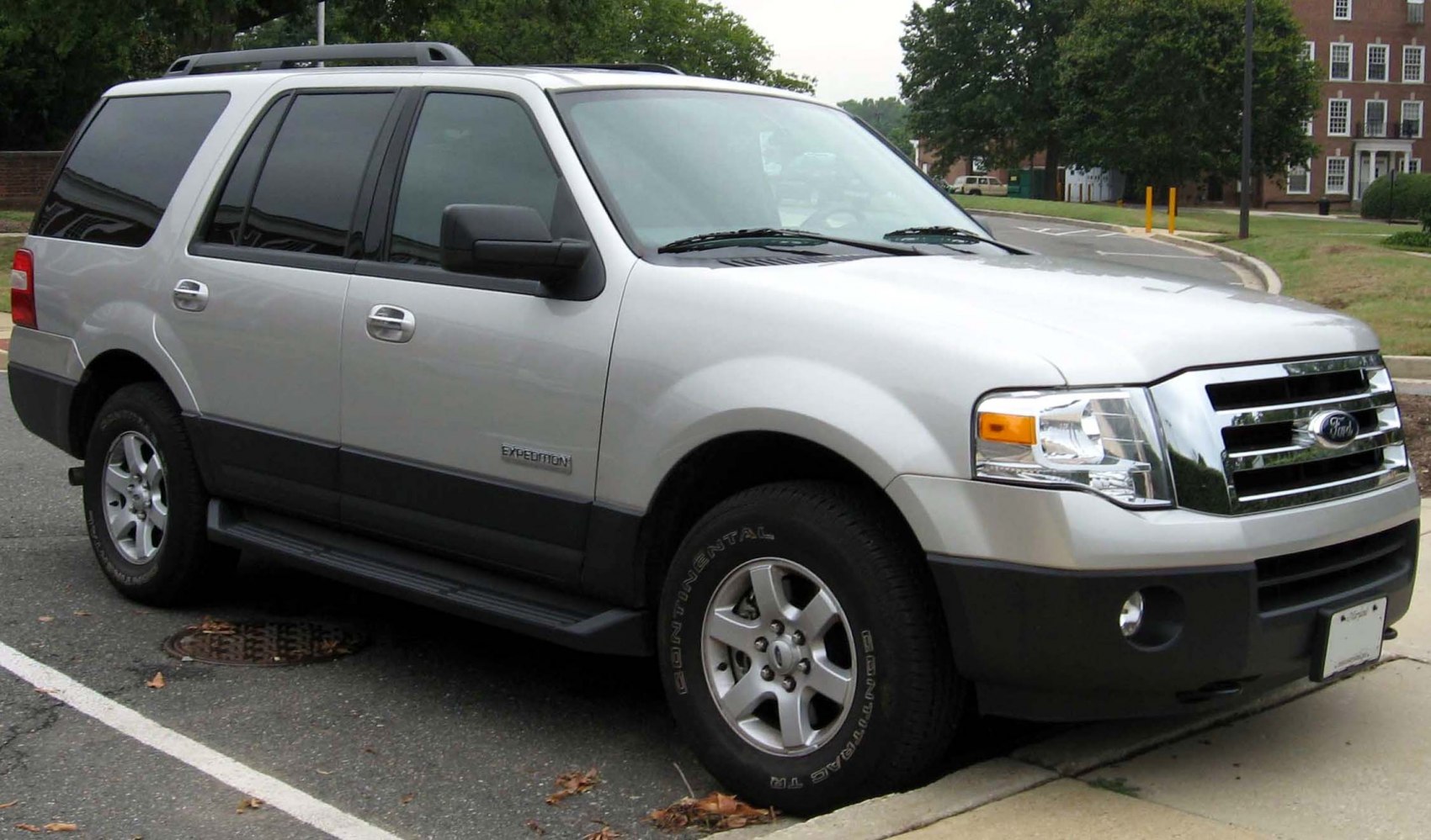 Side view of large SUV with chrome grille and tinted windows
