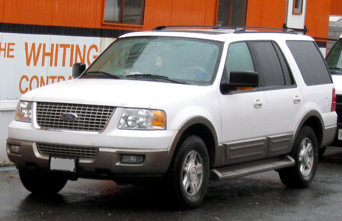 Two-tone SUV with roof rails and side steps