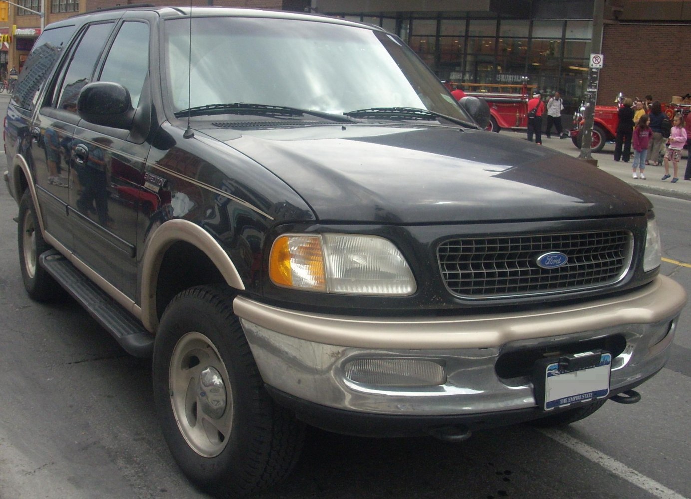 Black SUV front side with headlight and grille