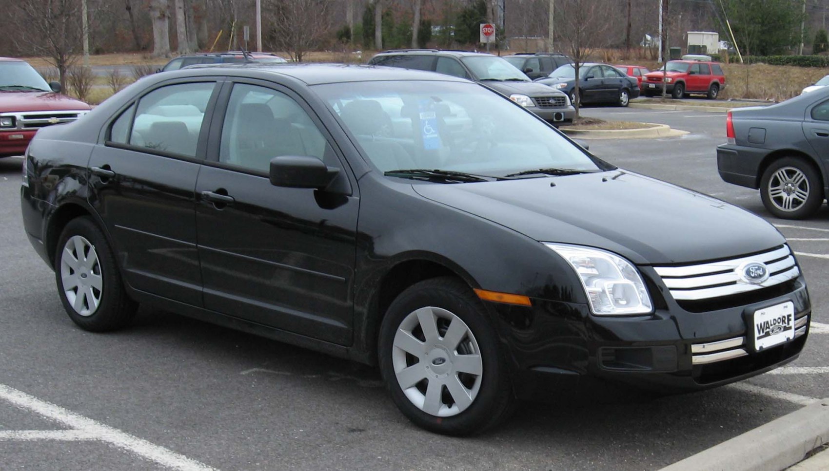 Black sedan with chrome grille and alloy wheels