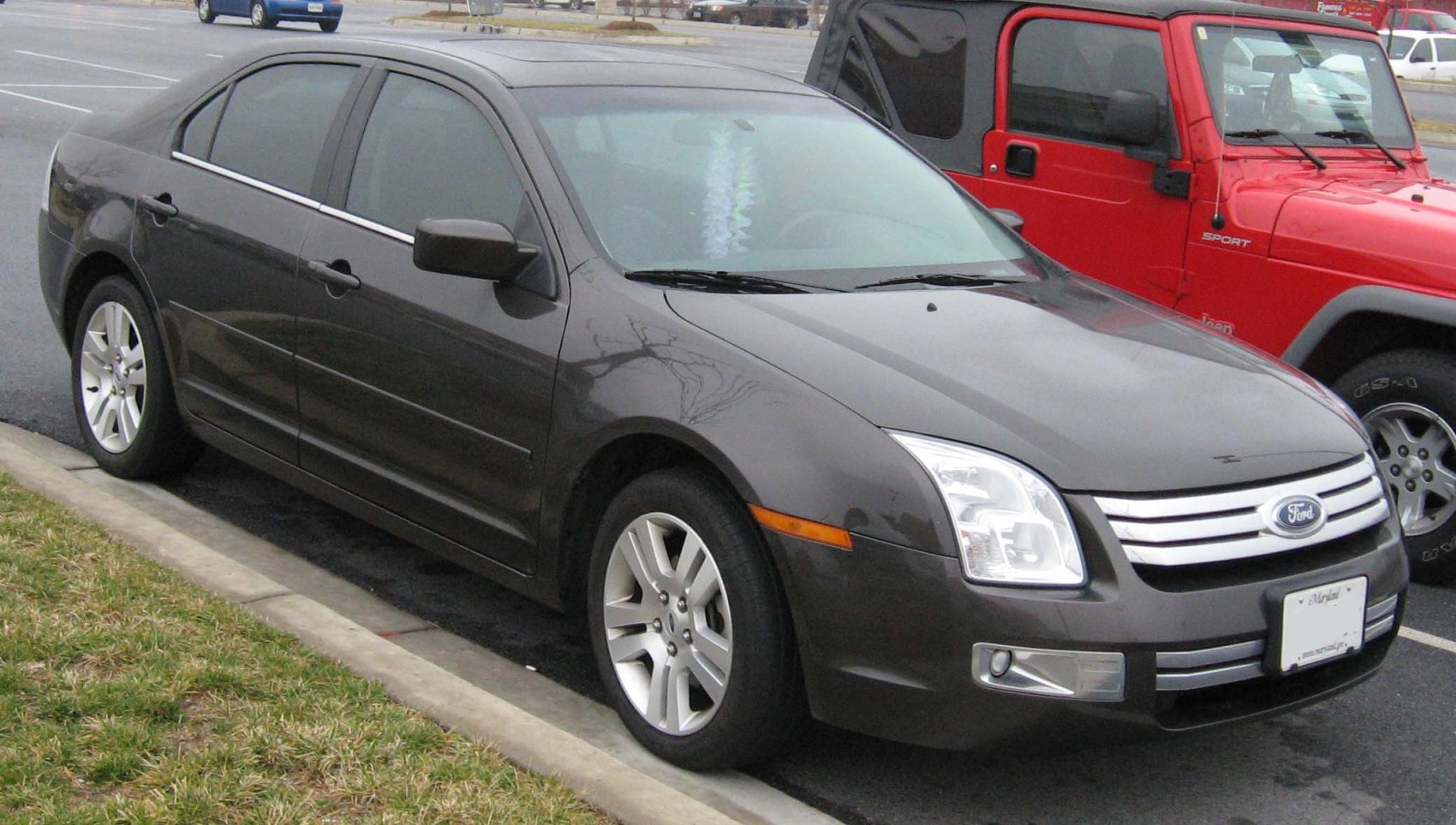 Front side view of sedan with distinct grille and alloy wheels