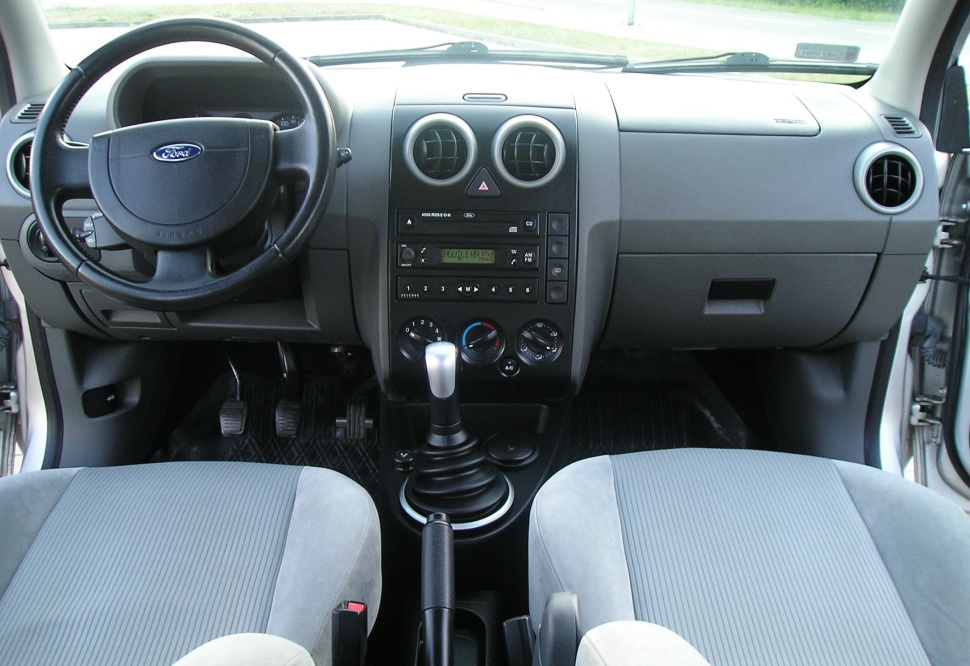 Dashboard with steering wheel, manual gear shift, and pedals
