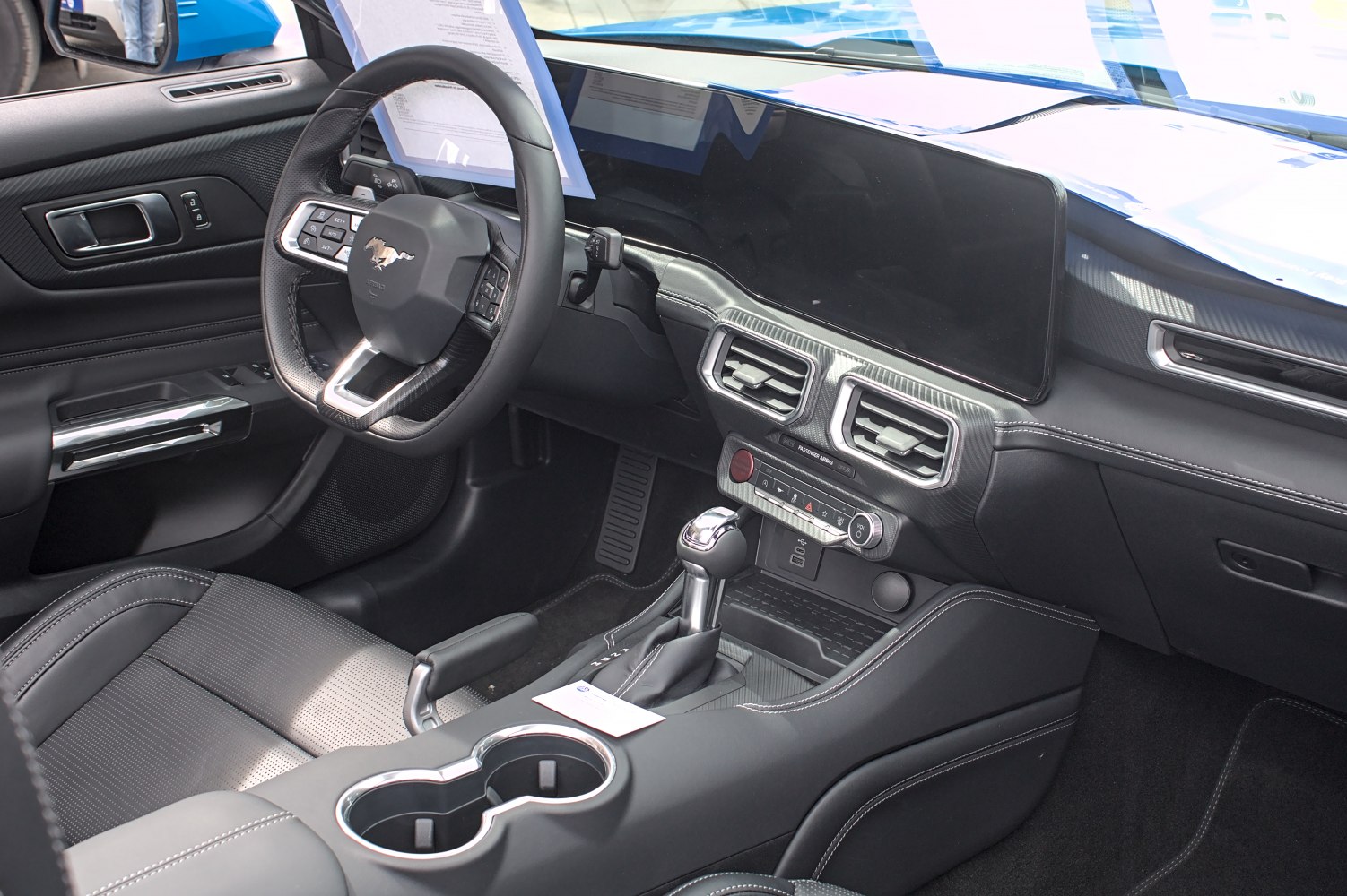 Interior dashboard and steering wheel with digital display and control buttons