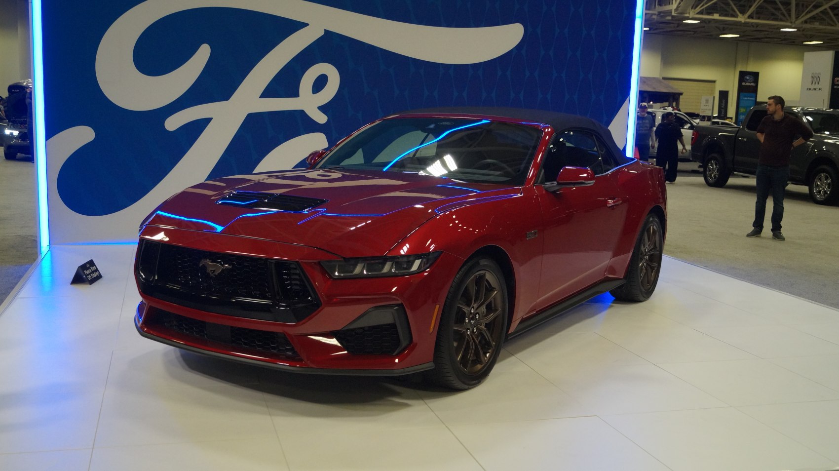 Red sporty convertible with aggressive grille and soft top