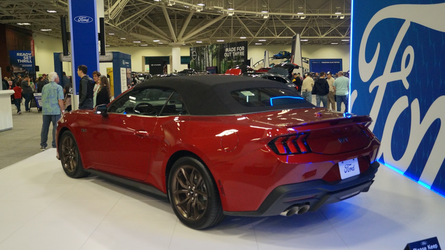 Convertible with black soft top roof and rear spoiler