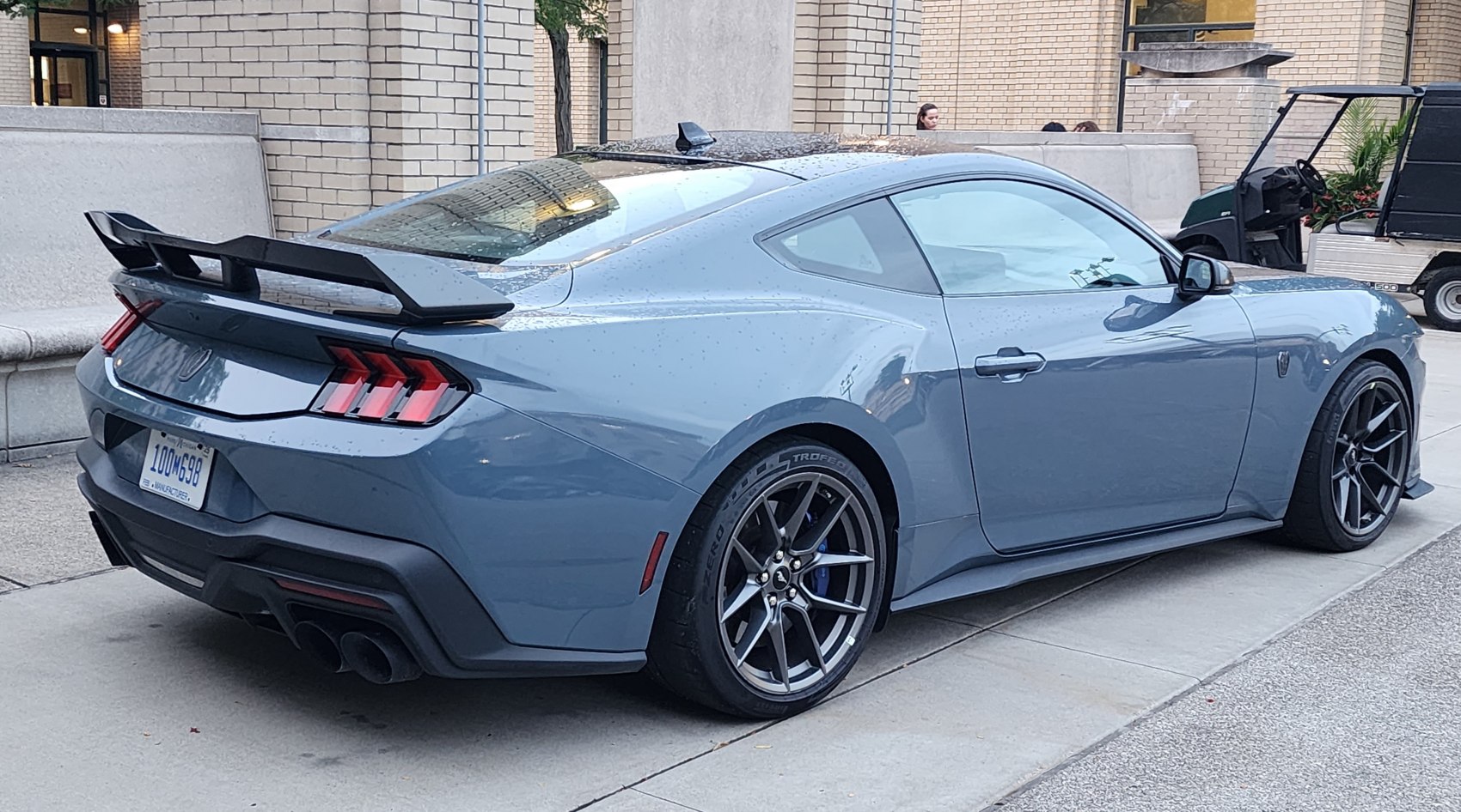 Rear side view with spoiler and sporty wheels of a modern coupe