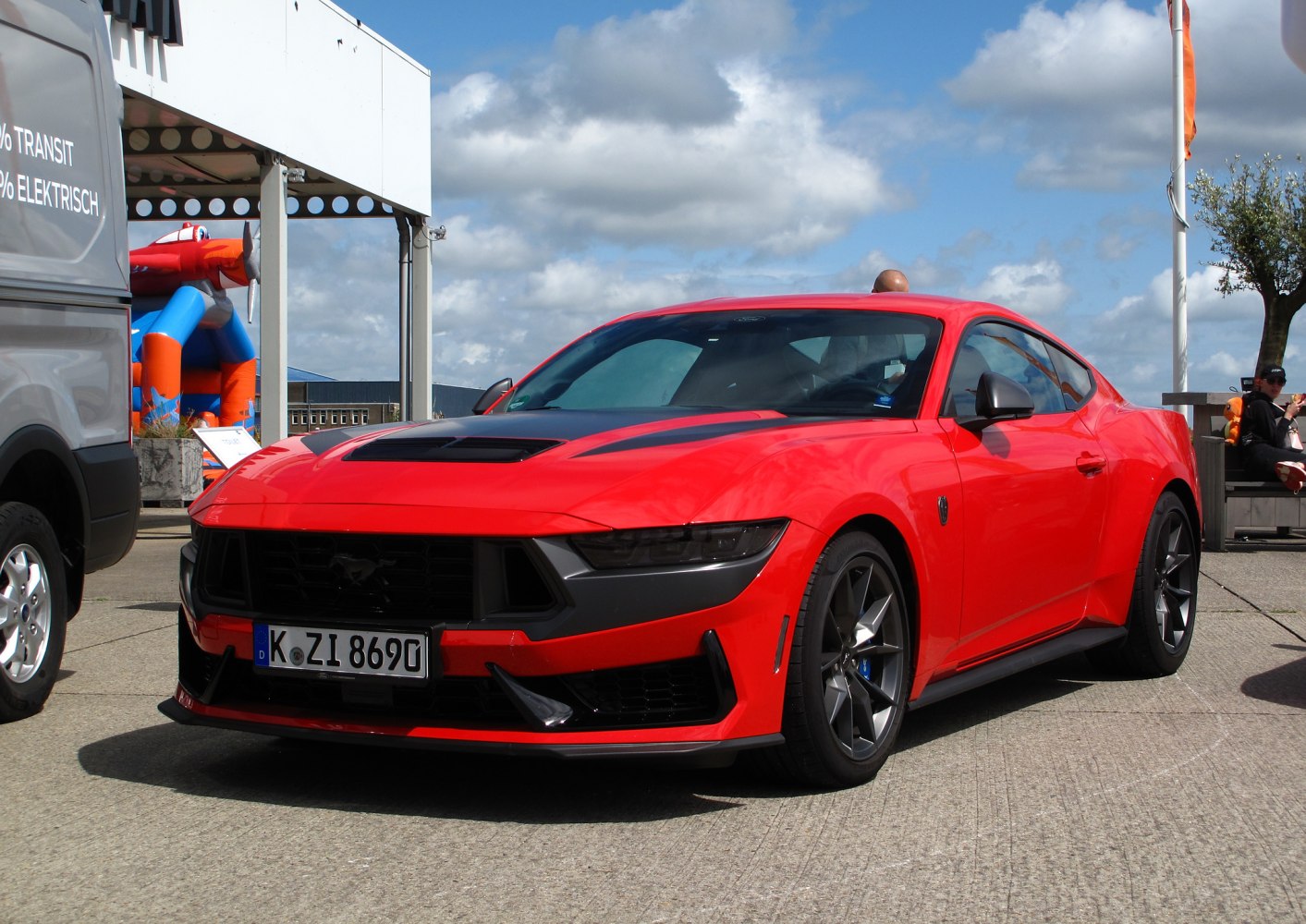 Red sports coupe with aggressive front and alloy wheels