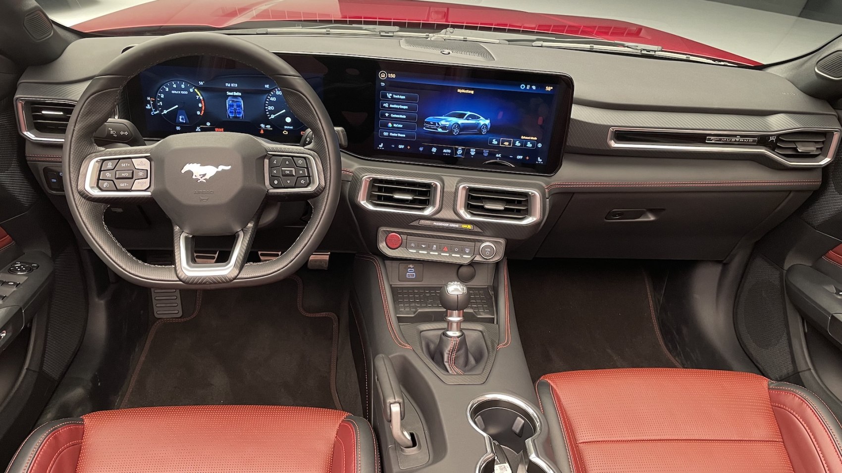 Digital instrument cluster, touchscreen infotainment, manual gearshift interior