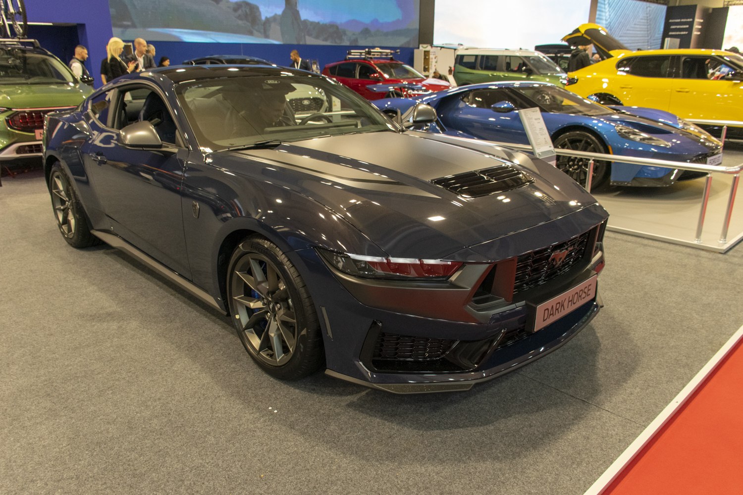 Front and side view of Mustang VII Dark Horse with vented hood and aggressive grille