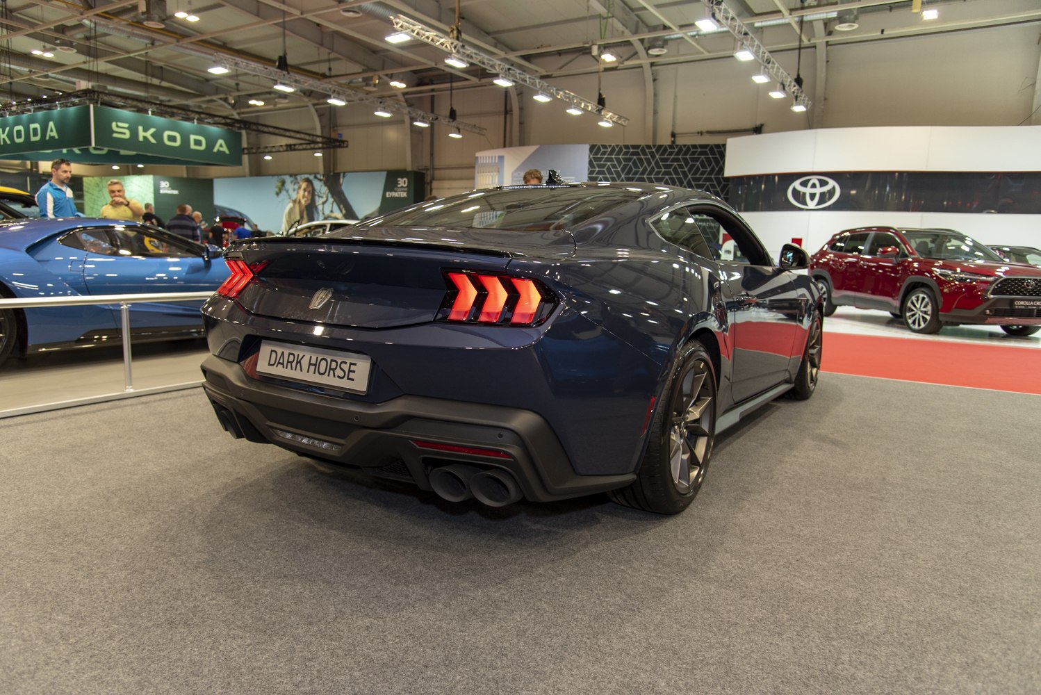 Rear view showing triple bar tail lights and sporty dual exhaust
