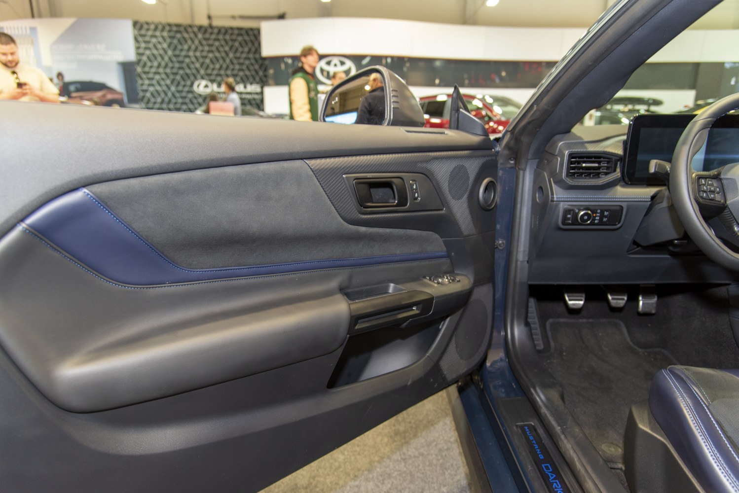 Interior door panel with driver controls and carbon fiber trim