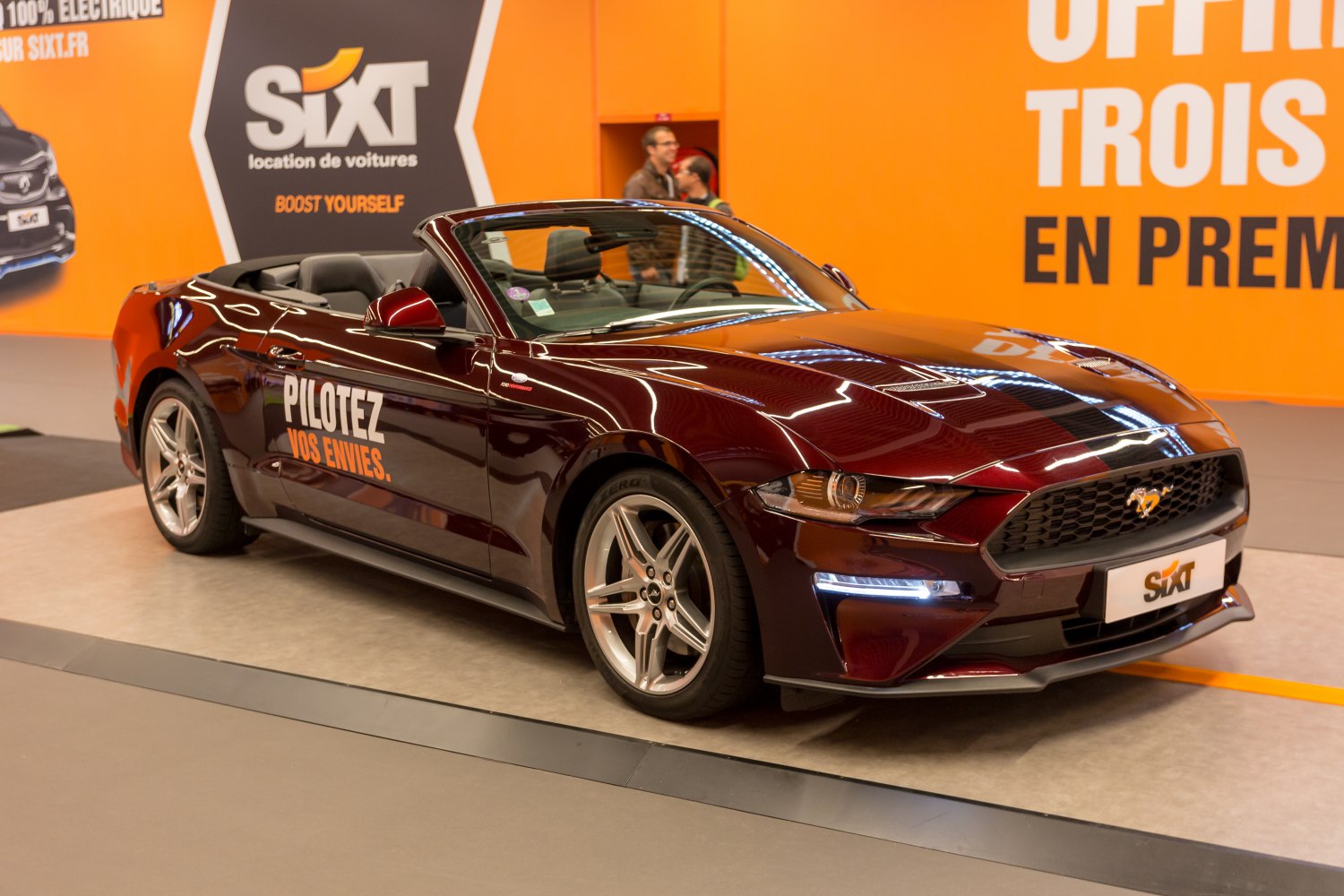 Front-side view of a dark red Mustang convertible with sporty design
