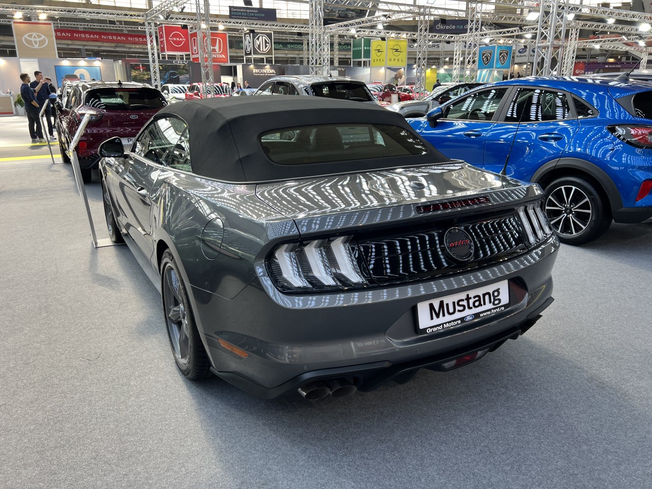Rear view of Mustang convertible with soft top and triple-bar taillights