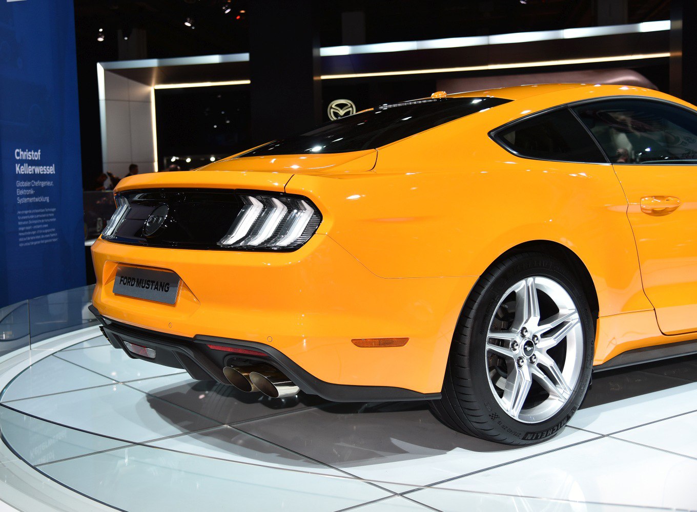 Rear LED tail lights and dual exhaust pipes of a sports coupe
