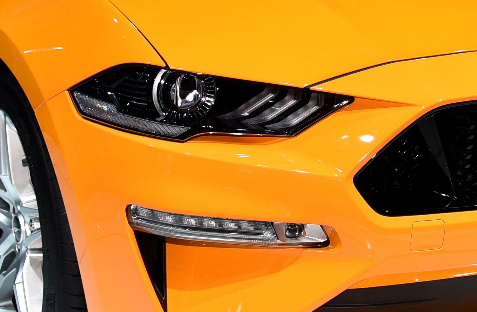 Close-up of front headlight and grille on a modern sportscar