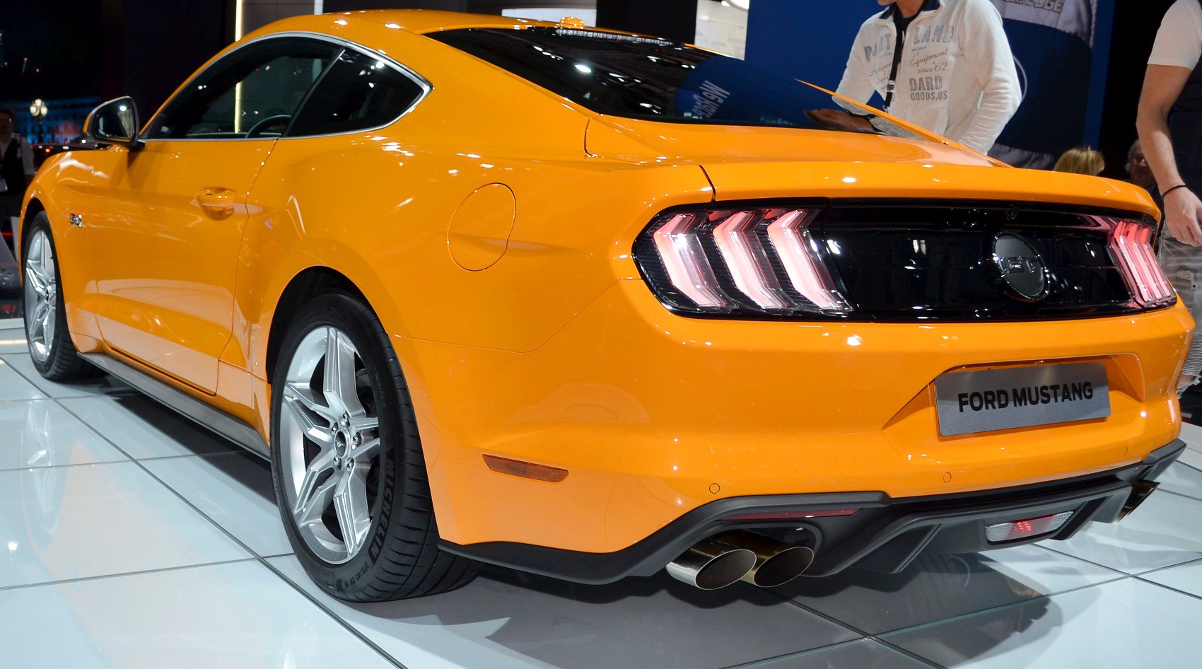 Rear and side profile with LED taillights, dual exhausts, orange exterior