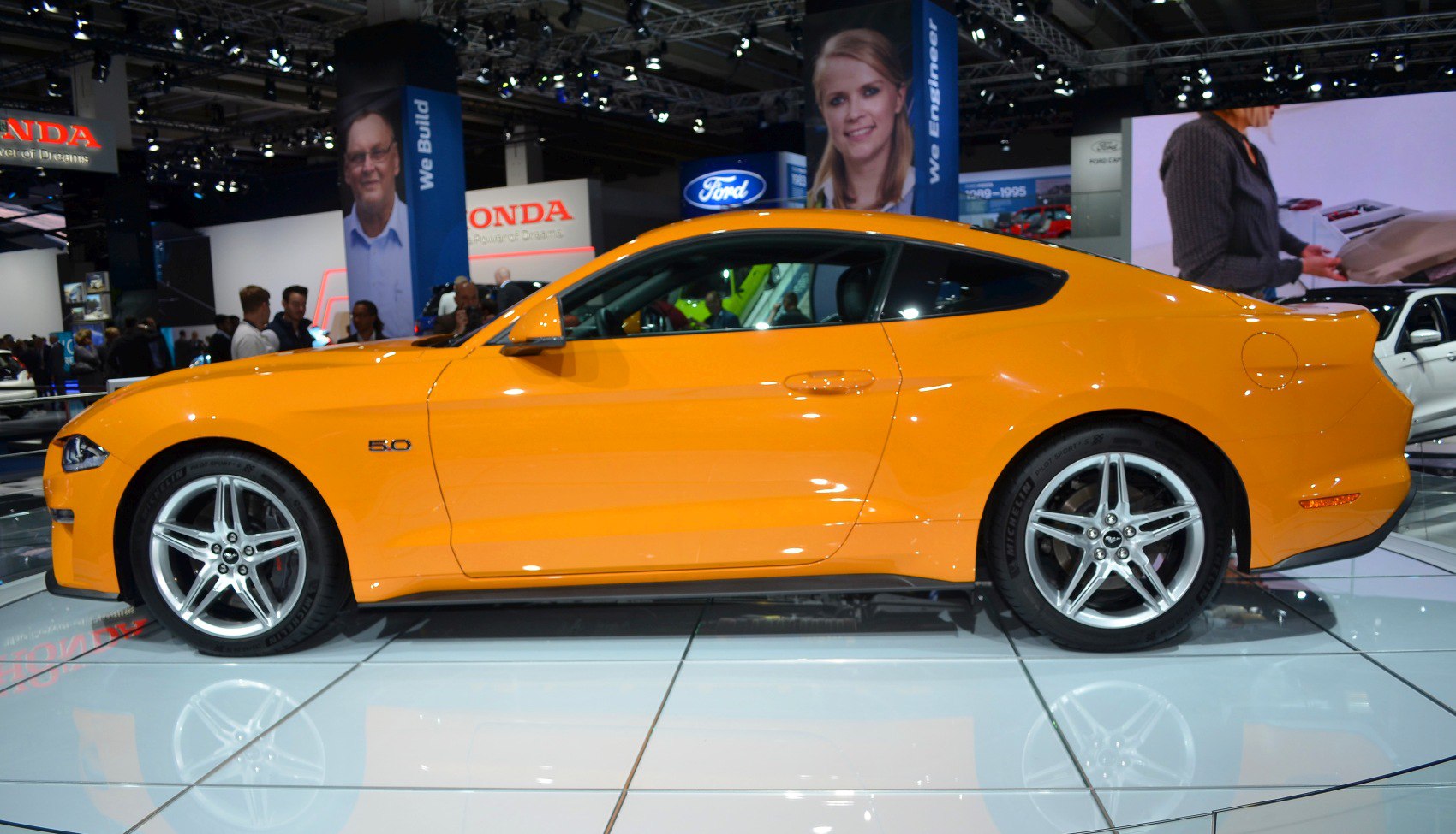 Side profile of coupe with 5.0 badge and alloy wheels