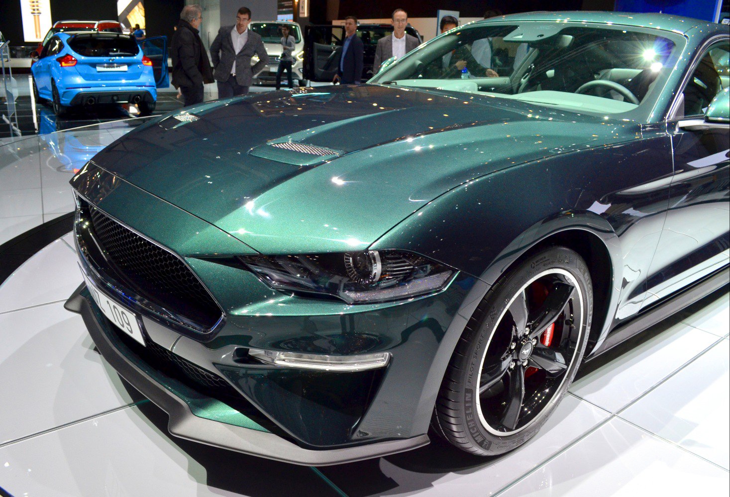 Aggressive muscle car front with ventilated hood and black alloy wheels