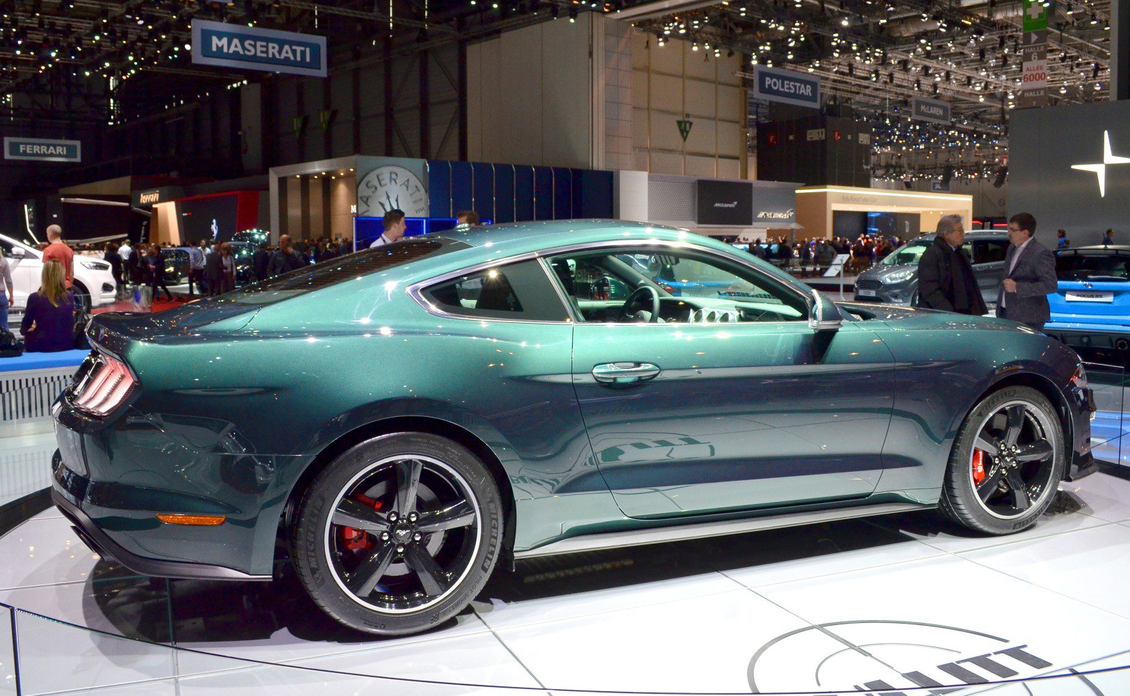 Sporty coupe side view with black wheels and red brake calipers