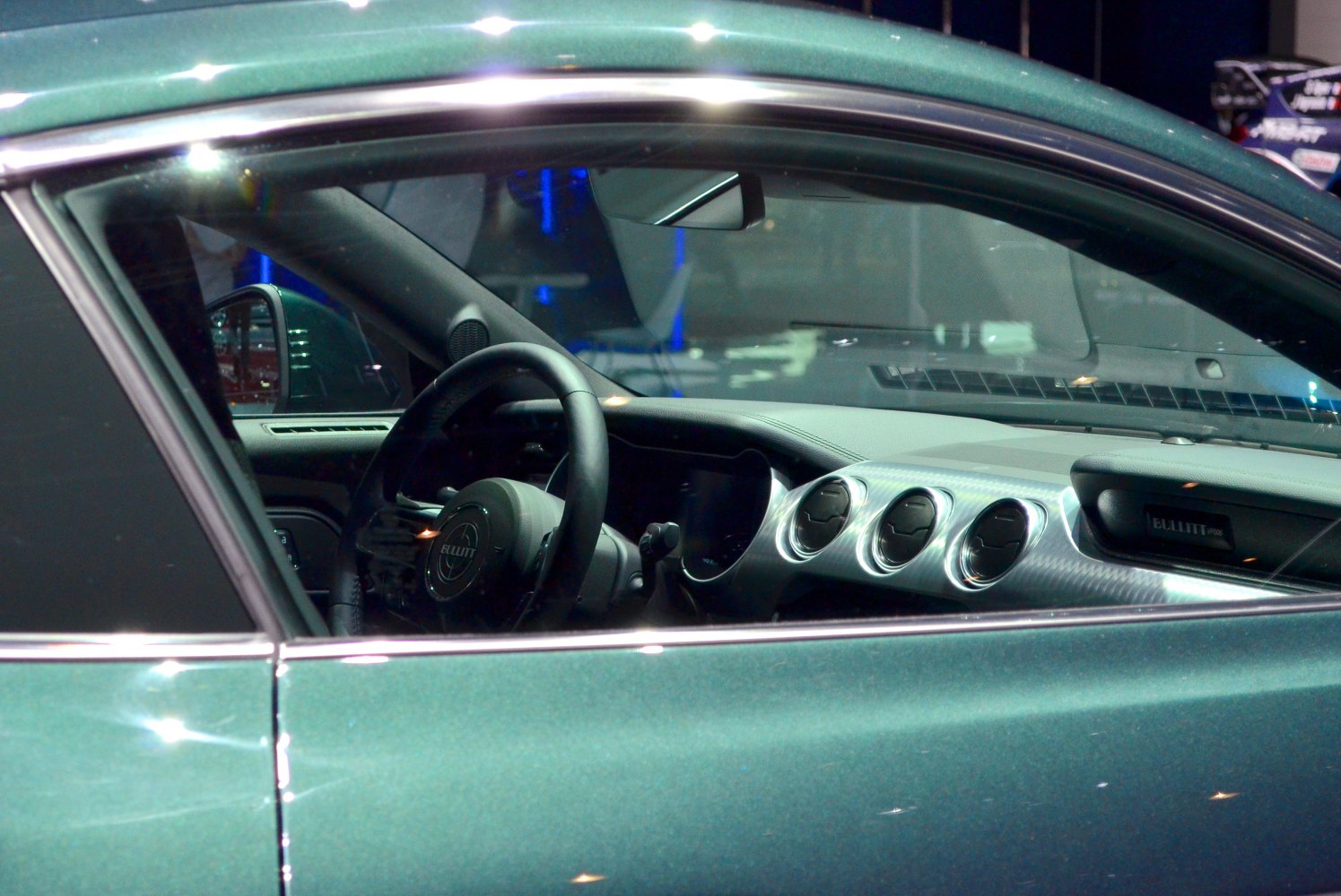 Car interior dashboard with circular air vents and steering wheel