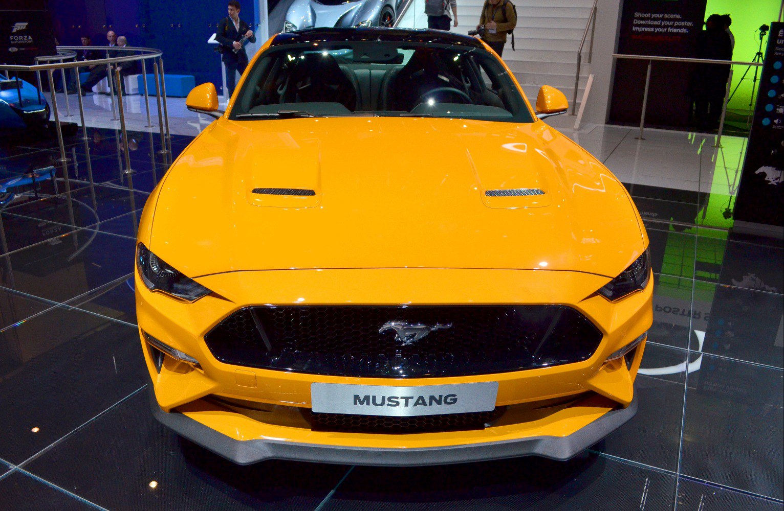 Front grille and dual hood vents of a modern muscle car.