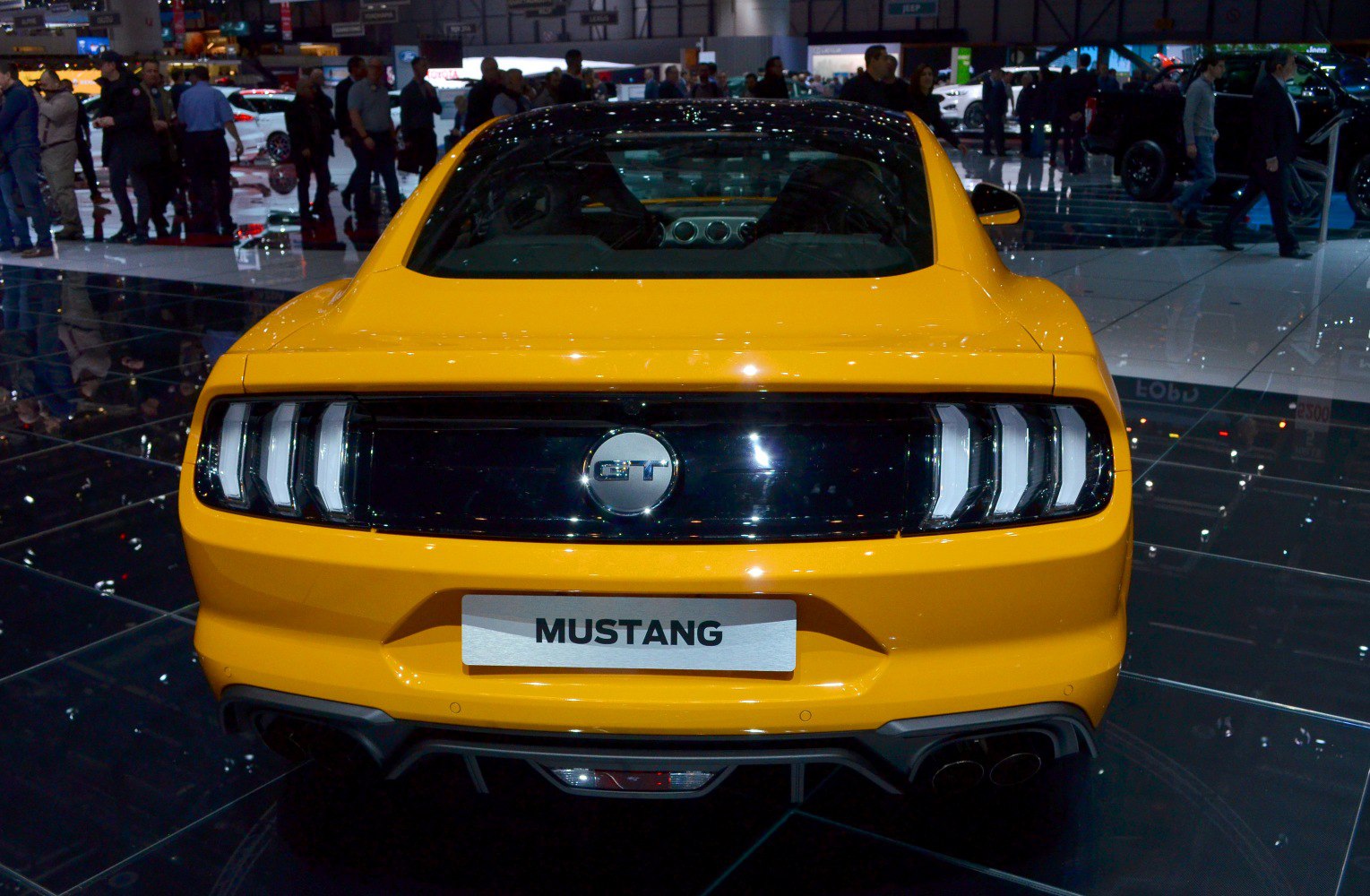 Rear view of Ford Mustang with triple-bar taillights and GT badge