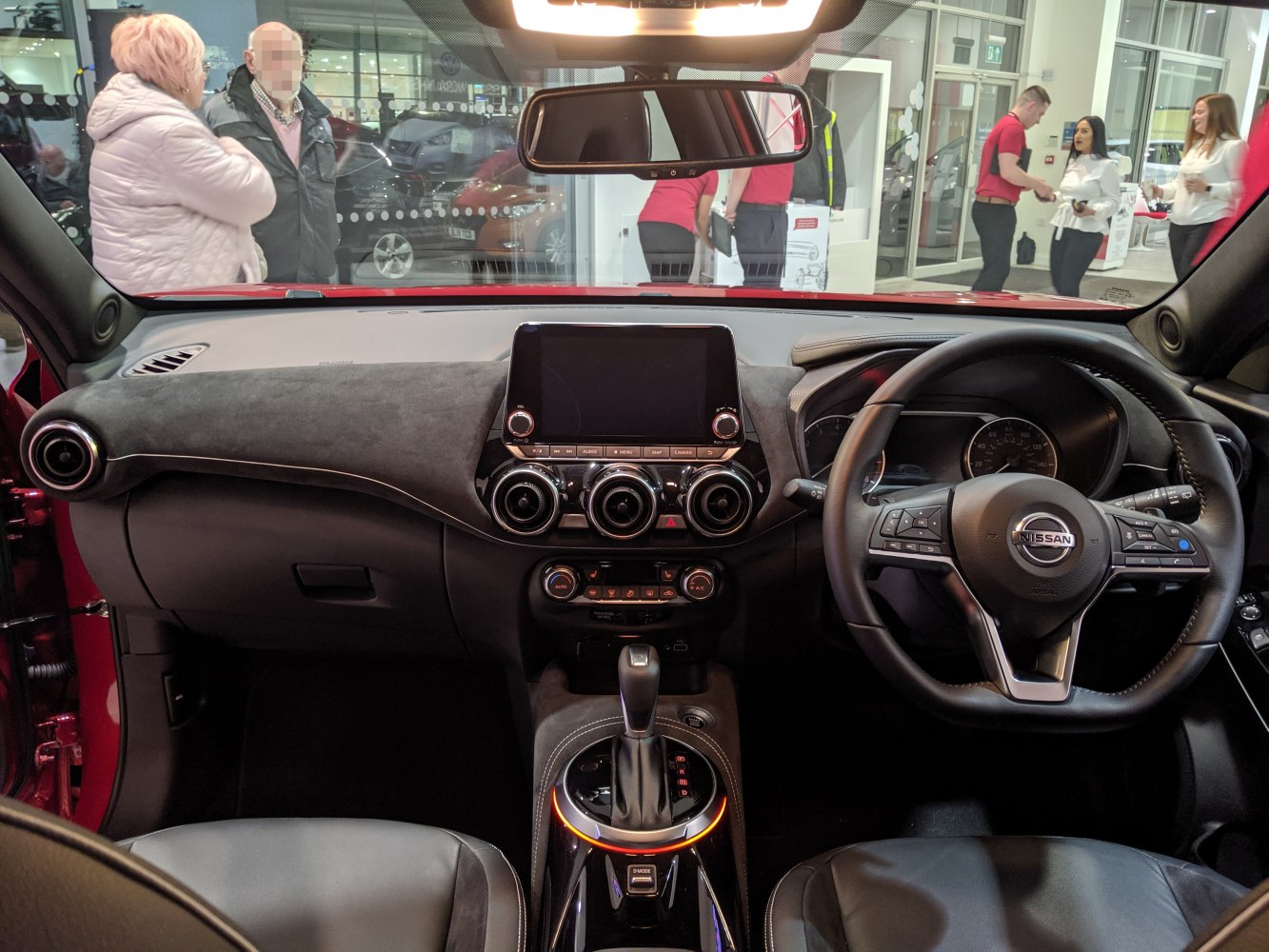 Interior dashboard with infotainment and steering wheel.