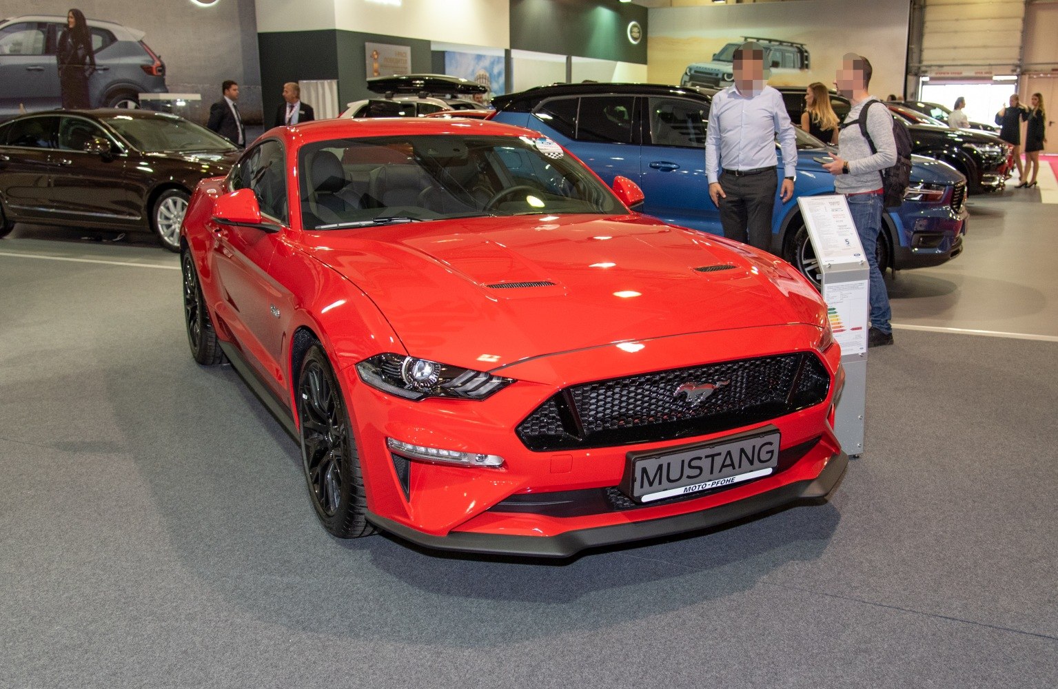 Red sports coupe front, black mesh grille, sharp headlights