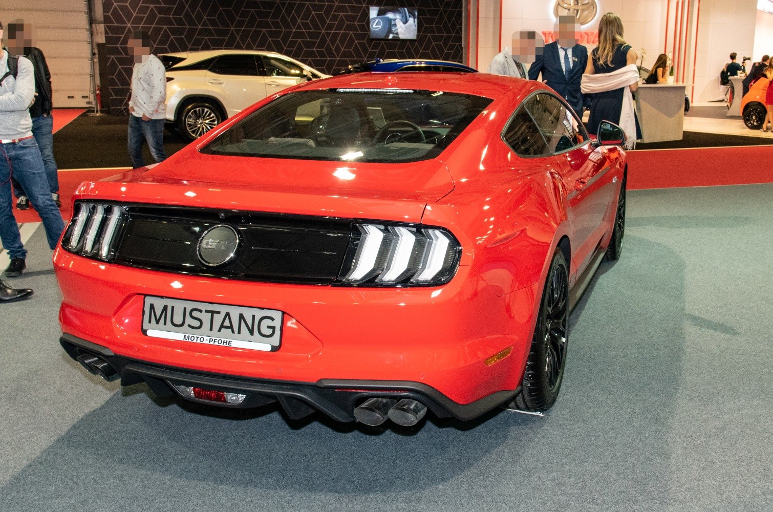 Red sports coupe rear with tri-bar LED tail lights and quad exhaust