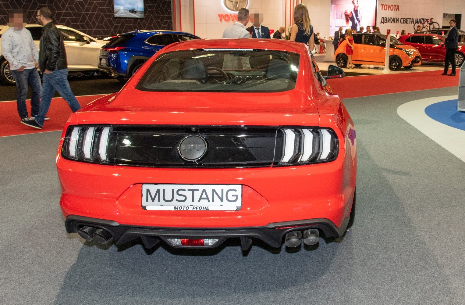 Rear view of sports coupe with LED tri-bar taillights and quad exhaust tips