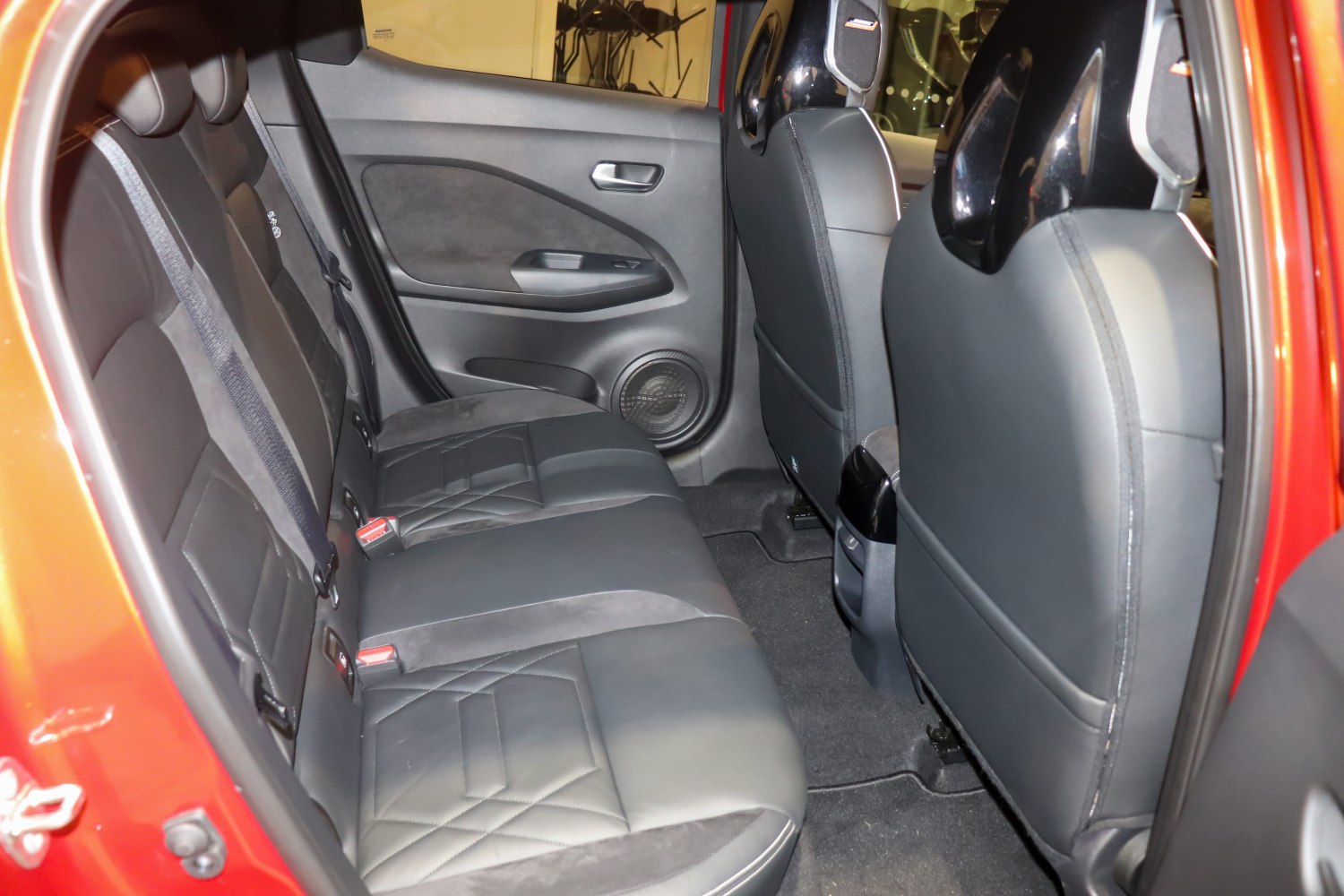 Black leather rear seats with quilted pattern and door speaker