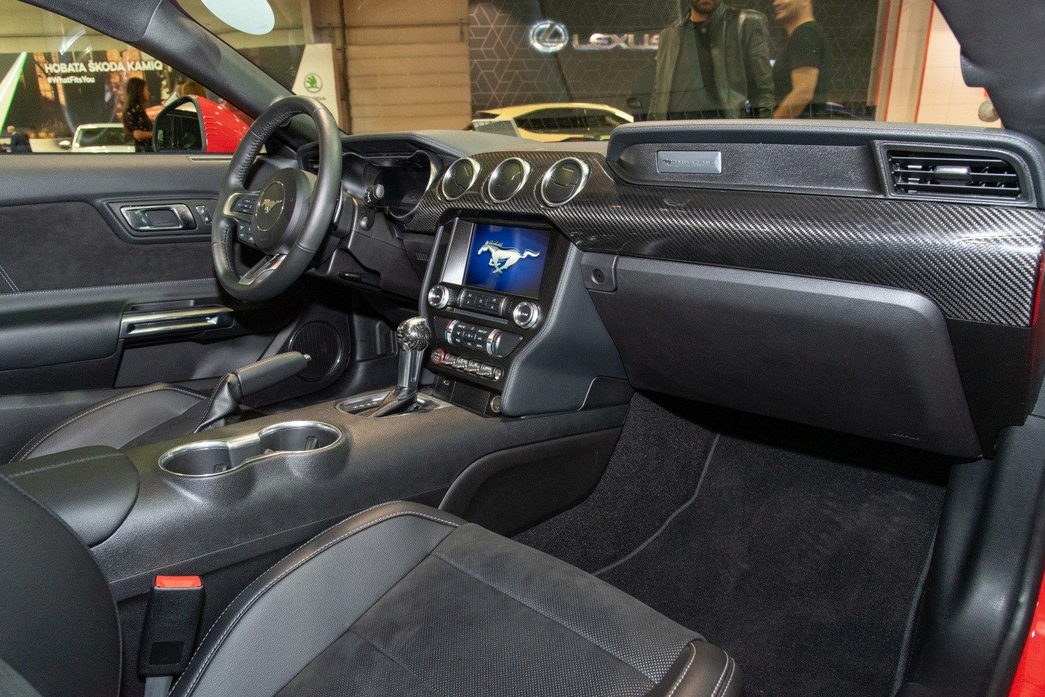 Interior dashboard with carbon fiber trim and center console with gear shifter and infotainment screen