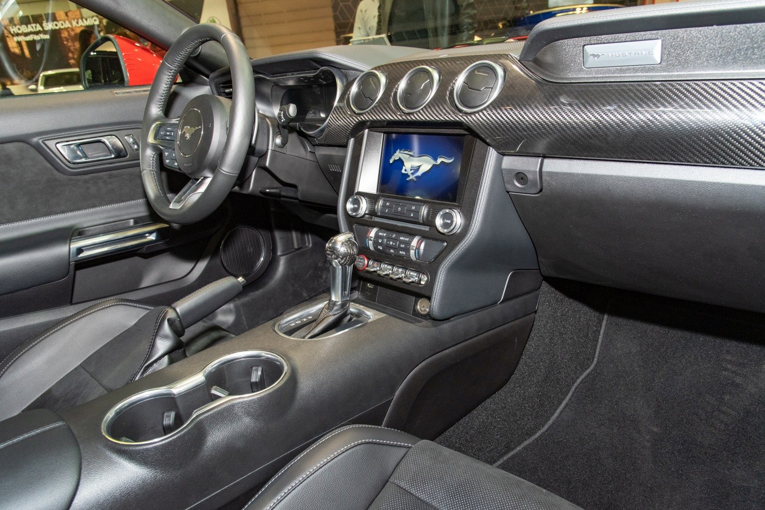 Dashboard and center console with digital screen and carbon fiber trim