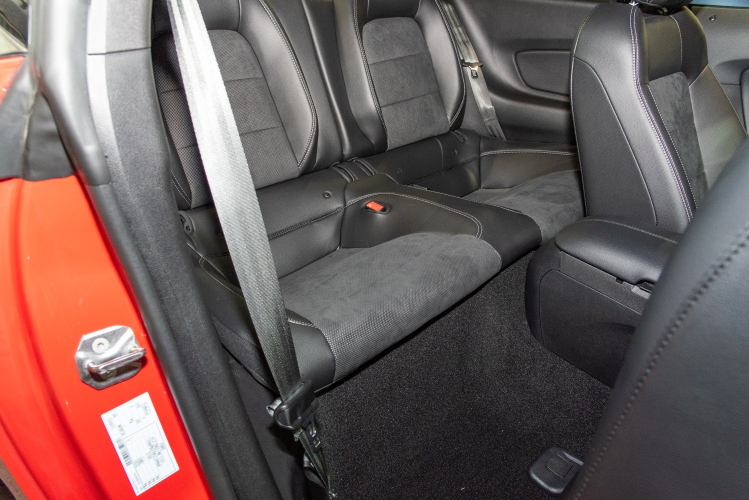 Rear seating area with leather and suede upholstery and seatbelt