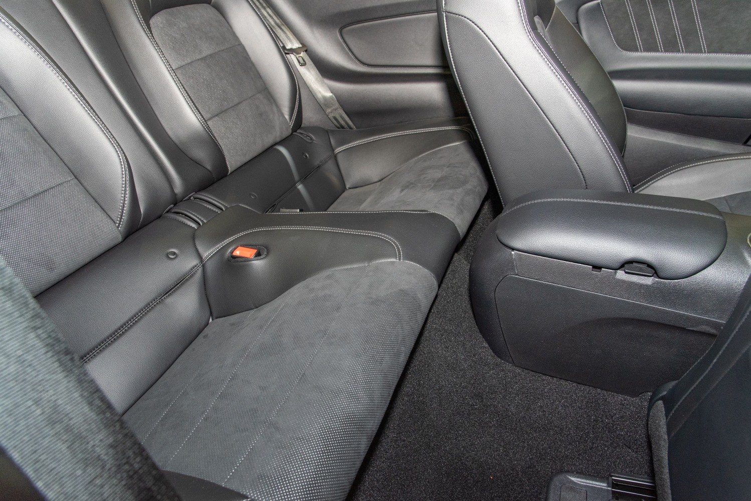Rear seat upholstery with leather and suede materials