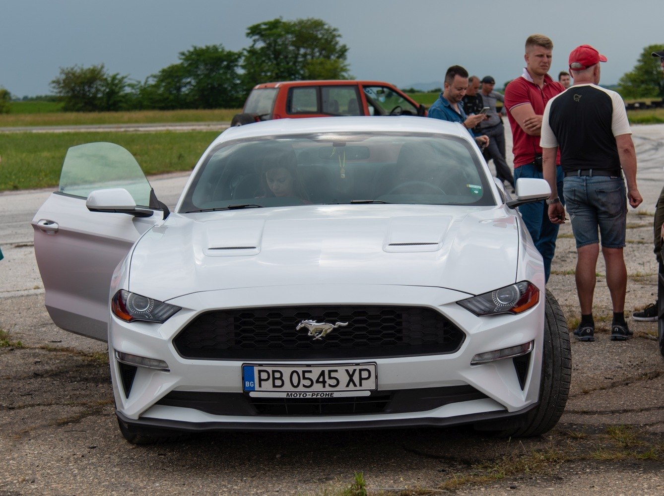 Front view with hexagonal grille and open driver’s door