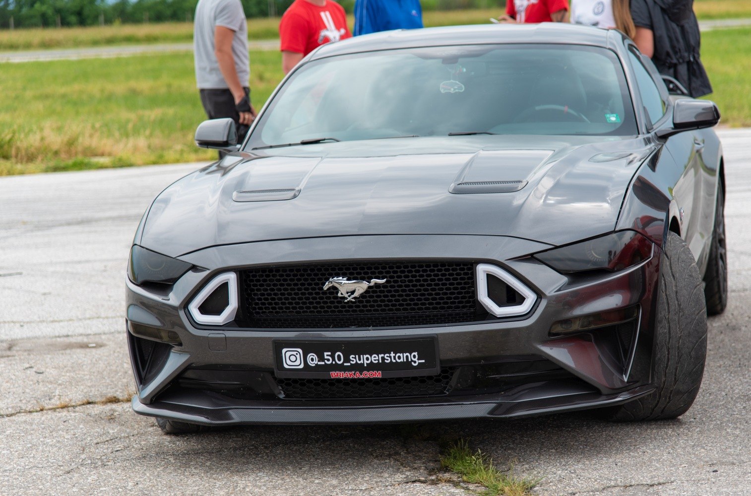 Aggressive front grille with iconic logo and dual hood vents.