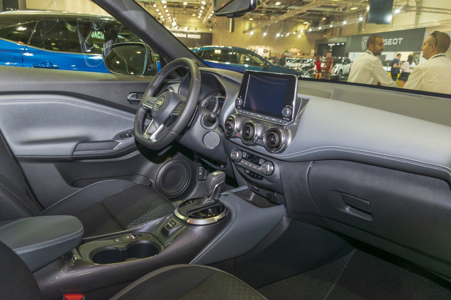 Modern car interior with touchscreen dashboard and steering wheel controls